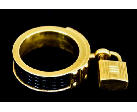 A Hermes Gilt Metal and Black Leather Kelly Scarf Ring with padlock charmVery faint scattered signs of scratching to the gilt