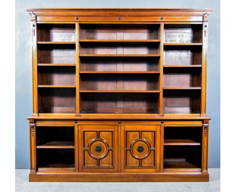 A Late Victorian Walnut Open-Front Bookcase, by John Taylor & Son, Edinburgh, with ebonised leaf roundels and plain pilasters