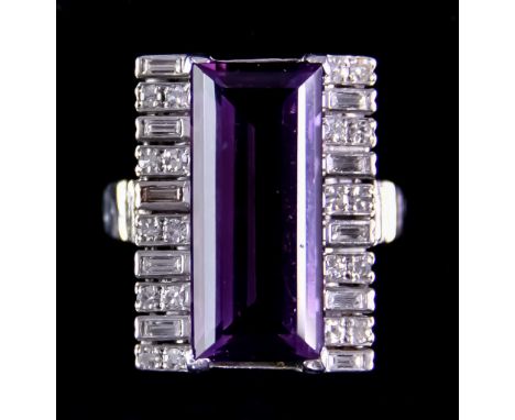 An 18ct White Gold Diamond and Amethyst Dress Ring, set with a faceted amethyst, approximately 20mm x10mm, flanked by alterna