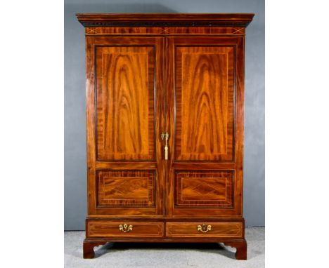 A George III Gentleman's Figured Mahogany Wardrobe, with moulded dentil cornice and inlaid with stringings, fitted hanging co