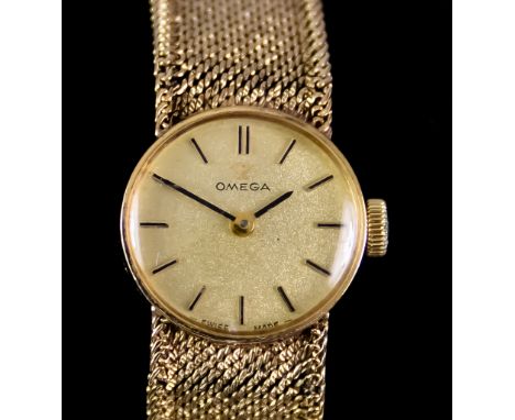 A Lady's Manual Wind Wristwatch, by Omega, 9ct gold case, 17mm diameter, gold dial with gold baton numerals, integral 9ct gol