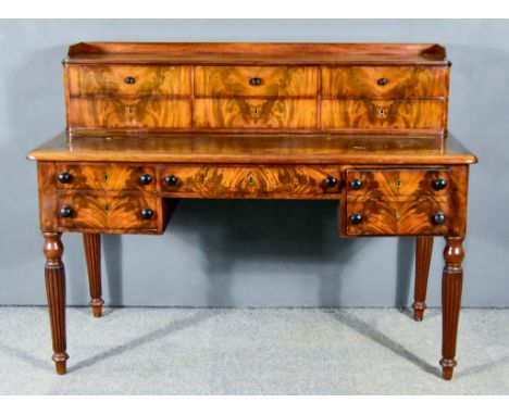 An Early Victorian Mahogany Kneehole Writing Table, with tray top superstructure fitted six drawers, the top with leather ins