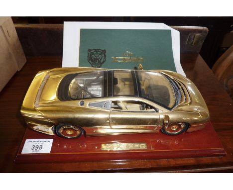 22ct gold plated scale model of a Jaguar XJ220 with associated C.O.A and paperwork