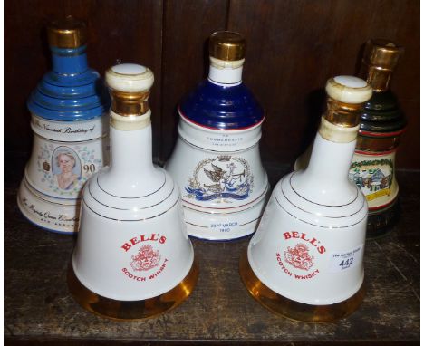 Five Wade china decanters full of Bell's Whisky