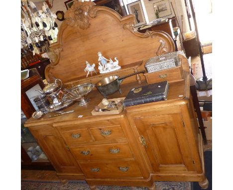 Victorian pine dresser/sideboard with carved arched back with one shelf flanked by drawers above four drawers and two cupboar