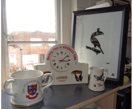 A china mantle clock advertising Guinness, reading 'Opening Time is GUINNESS TIME", a Guinness pottery water jug with transfe