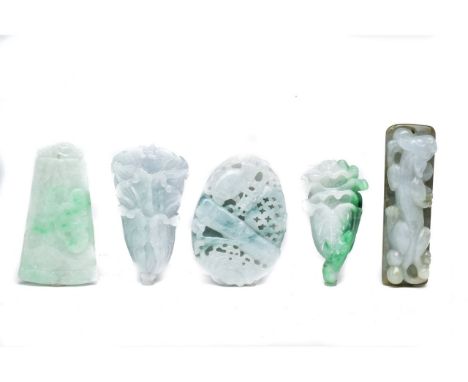FIVE CHINESE JADE CARVED PENDANTS. A set of five jade pendants and figures finely carved depicting mythical beasts and floral