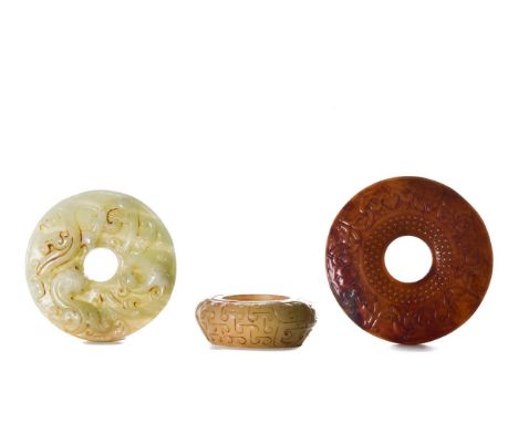 COLLECTION OF THREE CHINESE JADE CARVINGS. A pair of elaborately carved Bi disks and a beautiful jade small vessel. Size: L:s