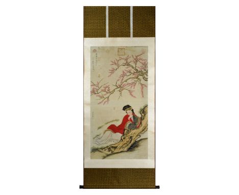 This Chinese scroll painting is beautifully decorated with a court lady dressed in red, seated under a cherry blossom three. 