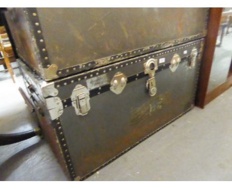 A LARGE FIBRE AND METAL BOUND CABIN TRUNK 