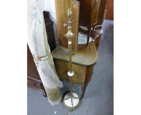 A BRASS AND MARBLE EFFECT STANDARD LAMP ON FOUR PAW FEET 