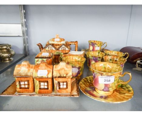 A COTTAGE WARE TEA SERVICE AND CONDIMENT SET AND A STAFFORDSHIRE TEA SET OF SIX PERSONS