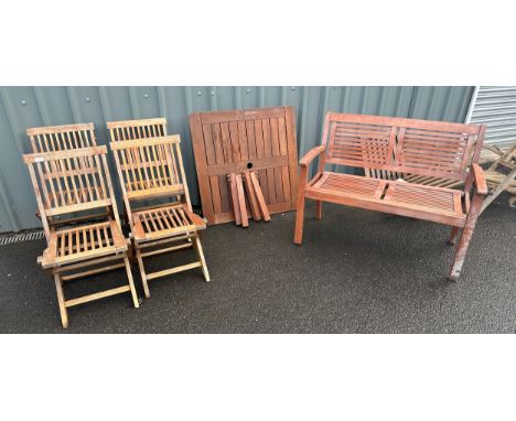 Four folding teak garden chairs, a two seater Merxx bench and a coffee table 