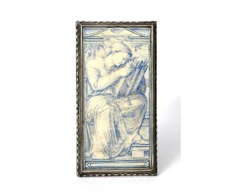 A Pre-Raphaelite tile plaque, rectangular, painted with a classical female figure, seated reading from a book, in blue on a w