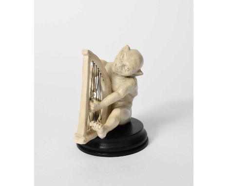 A Martin Brothers stoneware Imp Musician by Robert Wallace Martin, modelled seated, playing the harp, glazed white, with wire