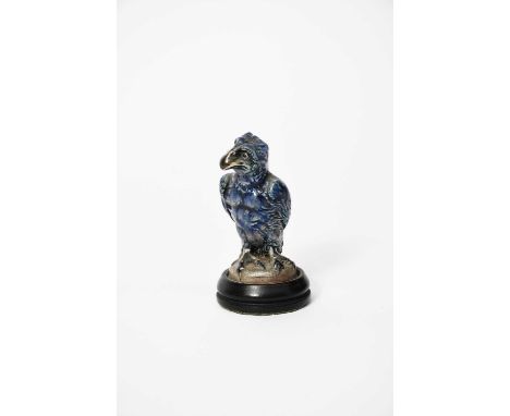 A Martin Brothers stoneware miniature bird by Robert Wallace Martin, modelled with claw feet, standing with wings tucked in a
