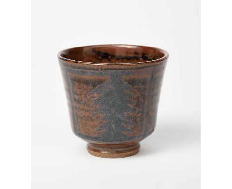 Henry Hammond (1914-1989)a stoneware footed tea bowl, flaring conical form covered to the foot in tenmoku, with brushed panel