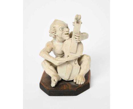 A Martin Brothers stoneware Imp Musician by Robert Wallace Martin, dated 1906, modelled seated playing the cello, glazed whit