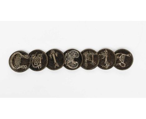 A Celtic bog oak and silver Cuibhig remembrance bracelet, seven circular bog oak panels, each set with a Celtic letter spelli
