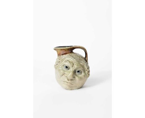A good Martin Brothers stoneware Barrister face jug by Robert Wallace Martin, modelled on one side with a smiling face with e