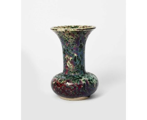 A Ruskin Pottery high-fired stoneware vase by William Howson-Taylor, ovoid with tall flaring cylindrical neck, covered in a m