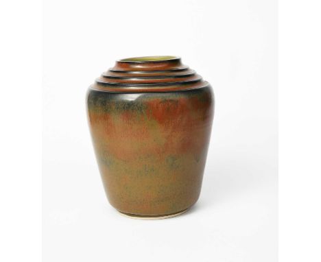 A large Poole Pottery vase probably designed by Harold Stabler, shouldered form, covered in a streaked rust and ochre glaze, 