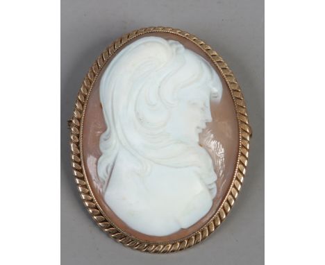 A 9ct gold carved shell cameo portrait of a young woman.