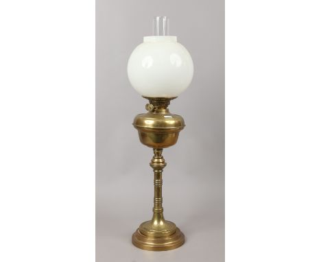 A Victorian brass based oil lamp with duplex burner and opaque glass shade