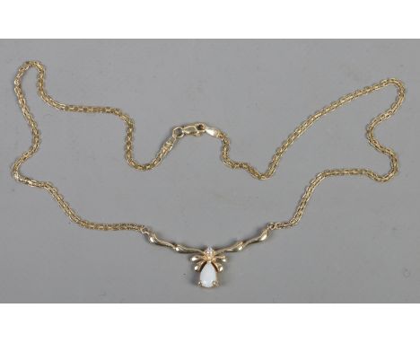 A 14 carat gold necklet on chain set with an opal and diamond