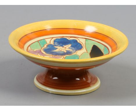 A Wilkinson pottery tazza by Clarice Cliff from the fantasque range, decorated in overglaze enamels with flowers.