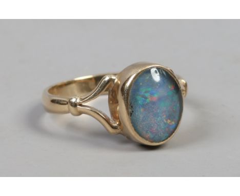 A 9ct gold opal doublet ring set on split shoulders, size N. Hallmarked, 2.42 grams gross weight.   Condition Report. To be u