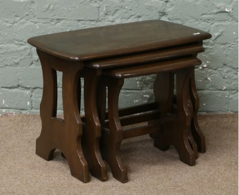 A nest of three oak Ercol occasional tables.