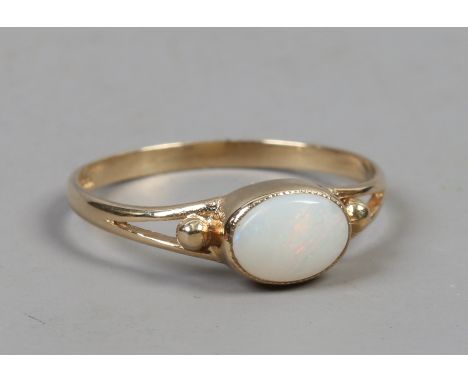 A 9ct gold ring set with an oval opal on split shoulders, size M.