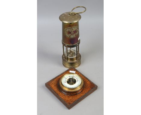 A.N.E Thomas & Williams Ltd miners lamp along with an oak cased barometer