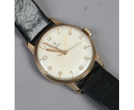 A gentleman's 9ct gold cased Tudor manual wristwatch with white enamel dial, gold fingers cased stamped Rolex, 30mm wide.   C