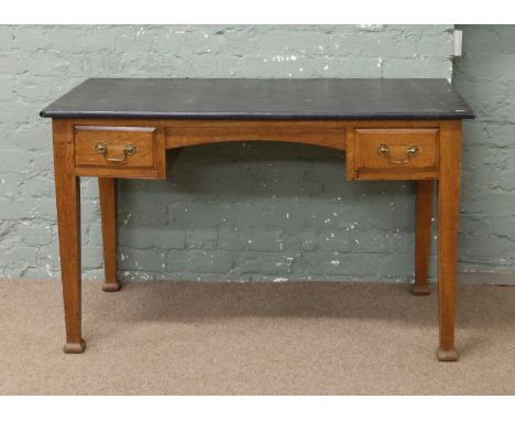 A George V light oak desk raised on square tapering supports.
