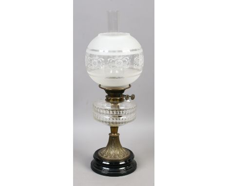 A Victorian brass based oil lamp with glass font and etched glass shade.