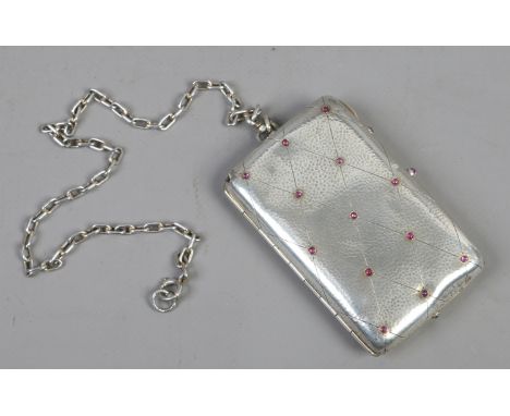A silver powder compact/aid memoir. Planished and set with cabachon rubies.