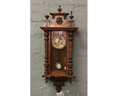 A walnut cased Vienna eight day wall clock striking on a gong.