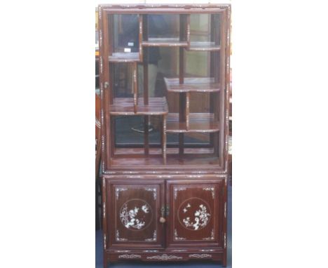 Chinese rosewood display cabinet with Mother of Pearl inlay, a mirrored back panel, above a two door cabinet. 82cm wide, by 3