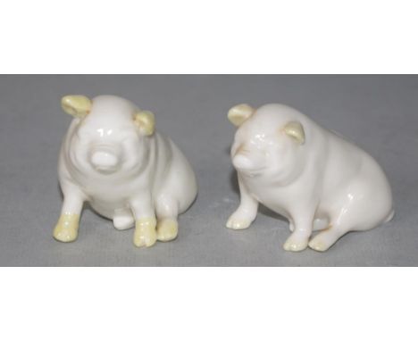 Pair Belleek ceramic pig figures green mark to bases. (Height 7cm approx, each).