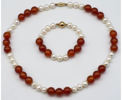 Carnelian pearl and gold necklace and bracelet necklace has a two tone gold clasp marked 750 MGD London approx carnelian bead