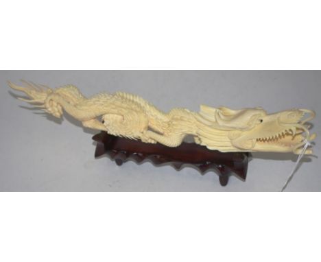 Vintage Chinese carved ivory dragon figurine on a timber stand, C1950, length 30cm approx,  This item may not be exported wit