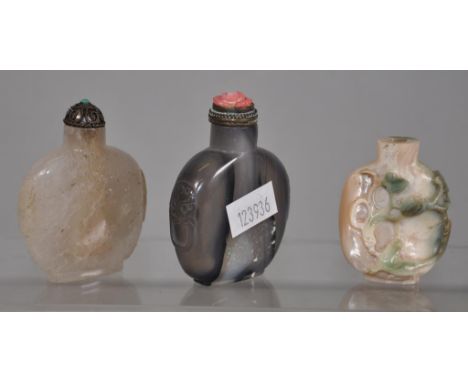 Three various Chinese snuff bottles including ceramic, with applied decoration, (missing stopper); crystal, with metal stoppe
