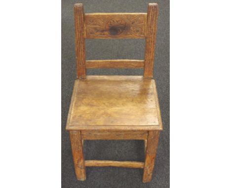17th century Spanish walnut provincial chair of small proportions, with a rectangular top rail carved in light relief with a 