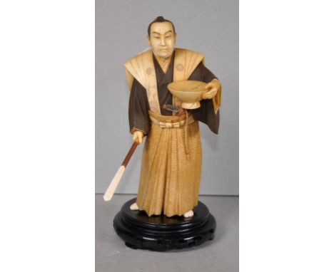 Antique carved Japanese ivory Samurai figure depicting a Samurai with a yari (spear), holding a large sake bowl in his arm. O