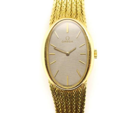 18ct gold Omega watch with a manual wind movement, solid gold bracelet, crown, case, applied baton and hands. Approx 24mm wid