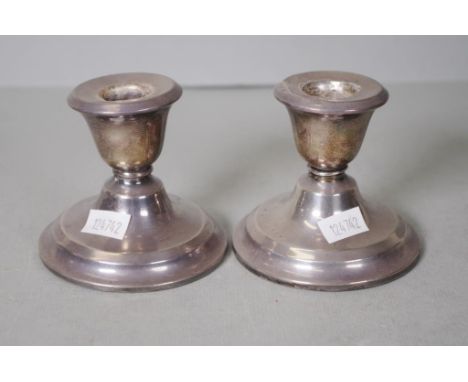 Pair George V sterling silver candlesticks Birmingham 1919, makers Blanckensee & Son, wood bases, (1 repaired). (Height 7cm a