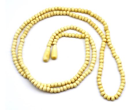 Ivory wrap around necklace C.1920s round beaded necklace with pear drop ends. Approx 144cm length, 7mm round bead thickness. 