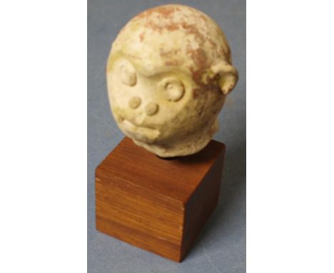 Mayan pottery handle mounted on wooden block in the form of a monkeys head, with faded green glaze finish. Late Classic ca AD